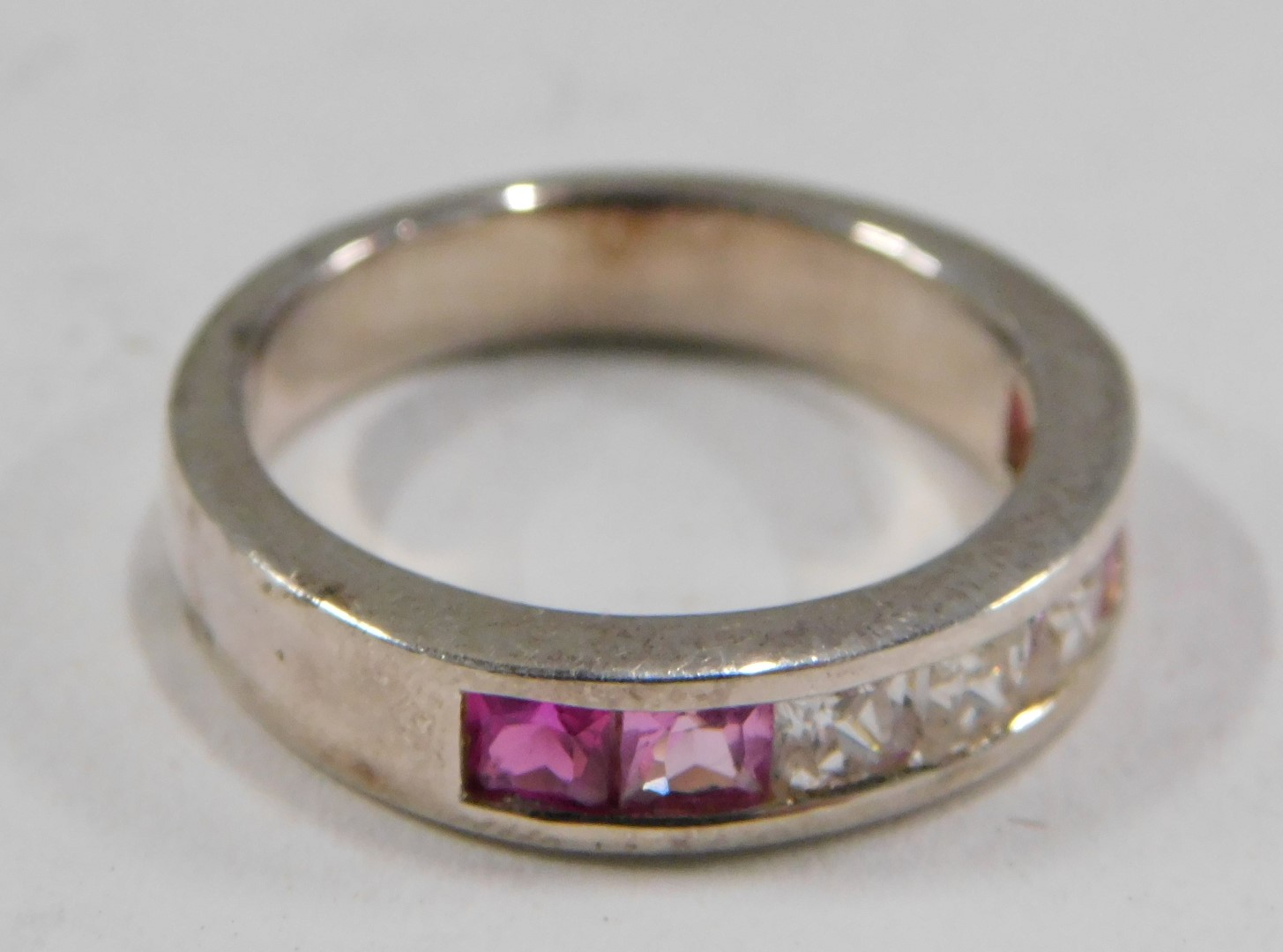 A dress ring, set with pink and white square set stones, channel set, on a white metal setting stamp - Image 3 of 4