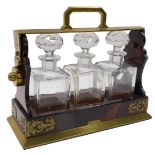 A 19thC Betjemann's Patent walnut and brass Tantalus, with four square section decanters and stopper