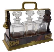 A 19thC Betjemann's Patent walnut and brass Tantalus, with four square section decanters and stopper