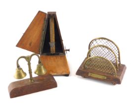 A French Maelzel metronome, in walnut case, a small brass letter rack, and a pair of horse bells. (3