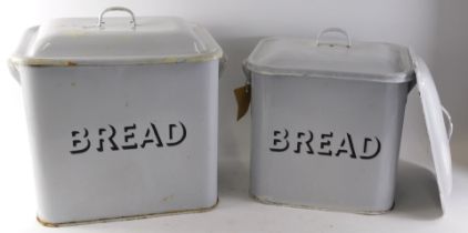 Two early 20thC enamel bread bins, each on white ground with black border, 32cm and 31cm high, with