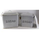 Two early 20thC enamel bread bins, each on white ground with black border, 32cm and 31cm high, with