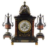 A late 19thC French black slate, marble and bronze clock garniture by HY Marc of Paris, the clock ca