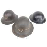 Three World War II ARP helmets, 29cm wide.