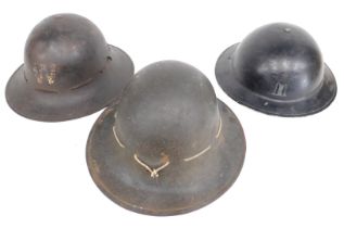 Three World War II ARP helmets, 29cm wide.