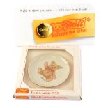 A Steiff small collectors plate Jackie 1953, and a white Perspex Steiff advertising plaque.