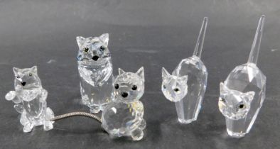 Five Swarovski crystal cat figures, comprising two stylised cats 5cm high, a playing kitten 3cm wide