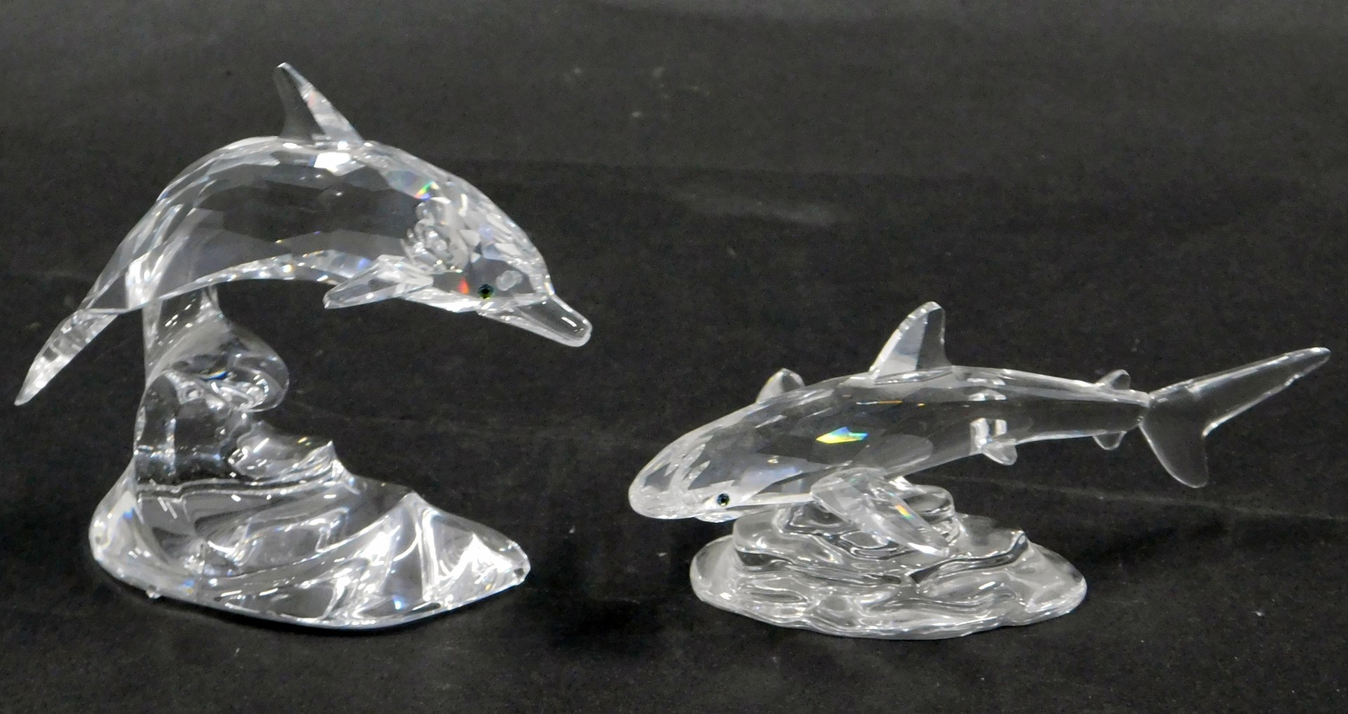 Two Swarovski crystal sea animals, comprising a dolphin riding wave, 9cm high, and a blue fin shark,