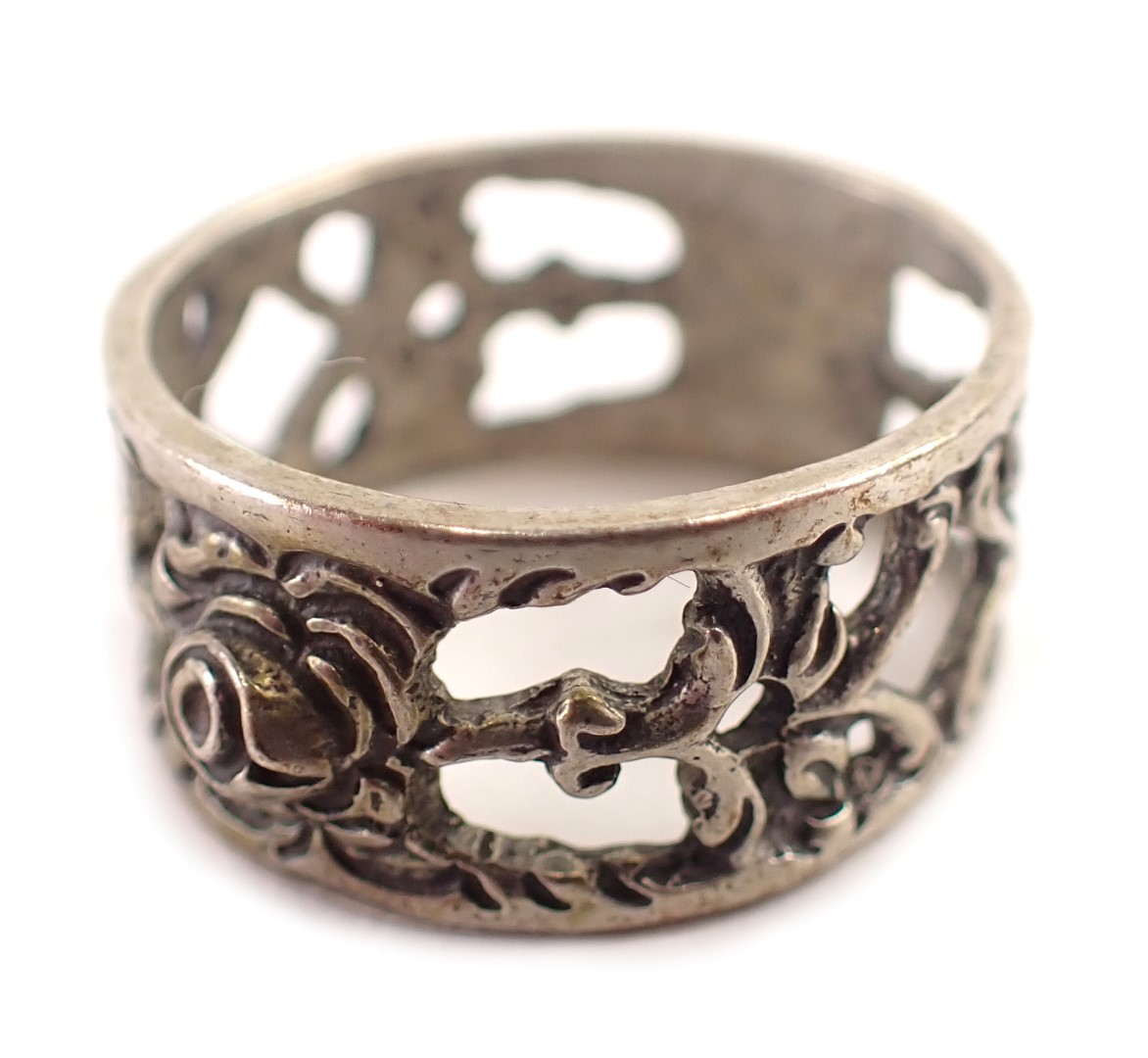 An Eastern wedding band, of pierced and scroll design, white metal stamped 835, ring size Q½, 4.9g a