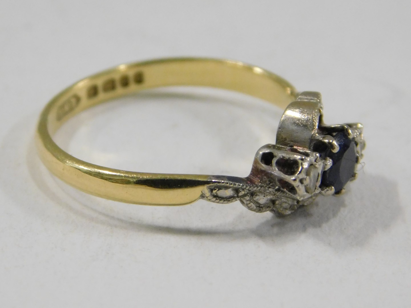 An 18ct gold sapphire and diamond dress ring, of twist design, set with oval cut sapphire and two il - Image 2 of 3