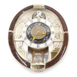 A Seiko Melodies in Motion oval musical wall clock, 45cm high.