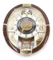 A Seiko Melodies in Motion oval musical wall clock, 45cm high.
