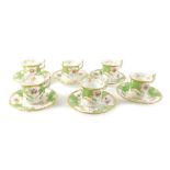 A Coalport coffee service, printed with flower sprays, within gilt and green bands.