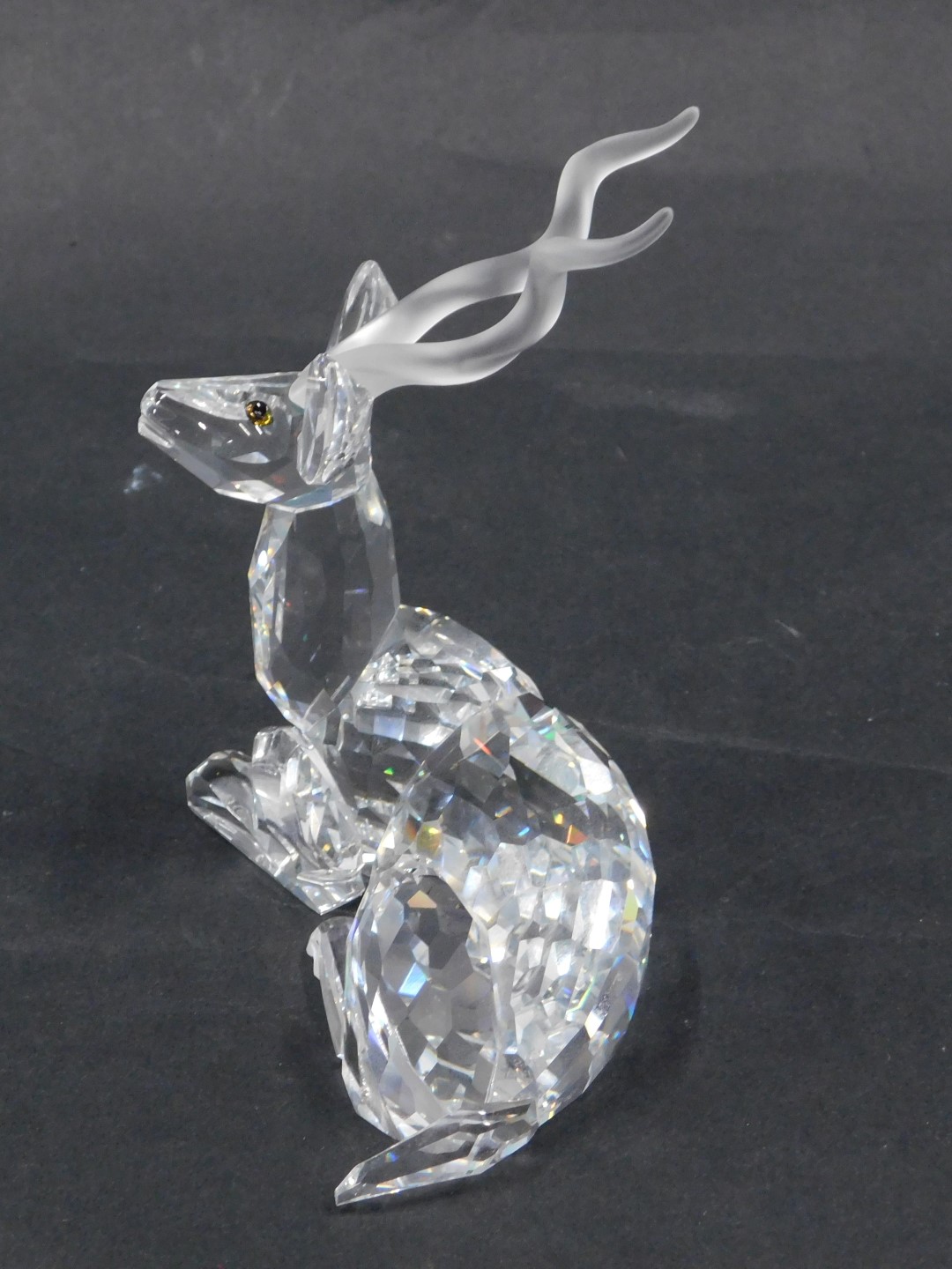 A Swarovski crystal seated antelope figure, with amber eyes, 10cm wide, boxed. - Image 2 of 2