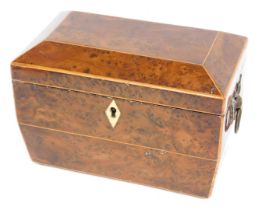 A Victorian yew sarcophagus shaped tea caddy, the hinged lid enclosing two lidded divisions flanked