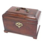 A George III mahogany tea caddy, the hinged lid with brass handle enclosing an interior with three d