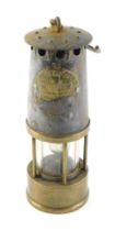 A Protector brass and steel miner's lamp, numbered 73, AF, 25cm high.