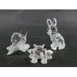 Three Swarovski crystal animal figures, comprising snail on perch 3cm high, fox 5cm high, and a frog