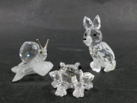 Three Swarovski crystal animal figures, comprising snail on perch 3cm high, fox 5cm high, and a frog