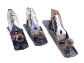 Three Stanley metal planes, each with a Stanley blade, 33cm wide.