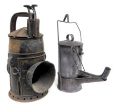 A railway hand lamp, GWR pattern, 33cm high, and a road worker's oil lamp, circa 1915, 32cm high. (2