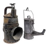 A railway hand lamp, GWR pattern, 33cm high, and a road worker's oil lamp, circa 1915, 32cm high. (2