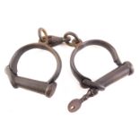 A pair of Hiatt Victorian cast iron handcuffs.