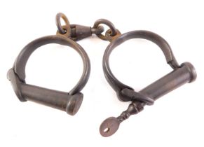 A pair of Hiatt Victorian cast iron handcuffs.