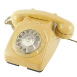 A mustard coloured vintage plastic telephone, stamped 746F, DFM, 80/2.