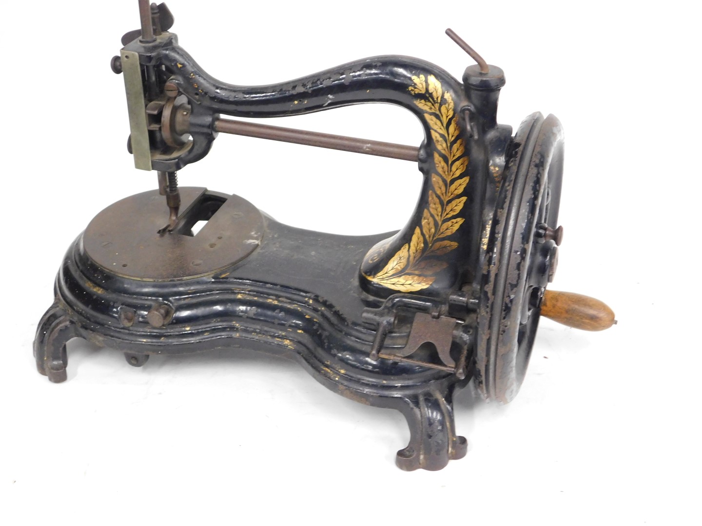 A 19thC sewing machine, on black cast base, with gilt leaf decoration and spun handle, on splayed le - Image 3 of 4