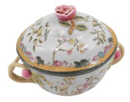 A late Oriental two handled jar and cover, decorated in European style with flowers, etc., 22cm wide
