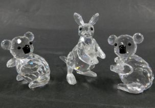 Three Swarovski crystal animals, comprising two koalas, 4cm high, and a kangaroo and baby, 6cm high,