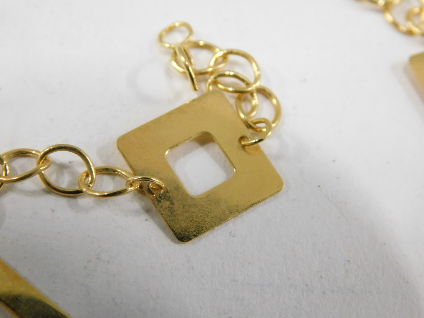 A modern bracelet, with four square link section, on yellow metal clasp, stamped 375, 18cm long, 1.9 - Image 3 of 3