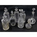 A collection of 19thC and later cut glass and other decanters and stoppers. (AF)