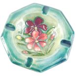 A Moorcroft spring flowers pattern ceramic ash tray, on a blue glazed hexagonal ground, 12cm diamete