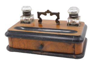 A 19thC walnut and ebonised desk stand, fitted with two glass inkwells, 6cm high, with ebony well an