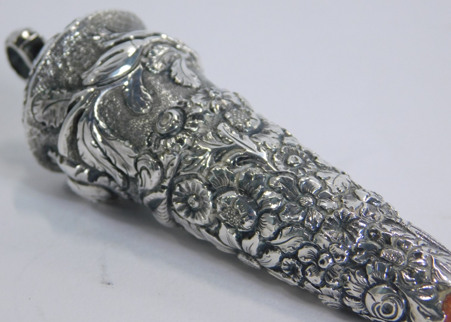 A Victorian teething rattle, with a coral base, with embossed floral top, white metal unmarked, 11cm - Image 3 of 3