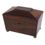 A Victorian rosewood sarcophagus shaped tea caddy, the hinged lid enclosing two lidded divisions, 20