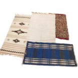 A collection of rugs, comprising a multicoloured weave, 136cm x 81cm, a cream Aztec type runner with