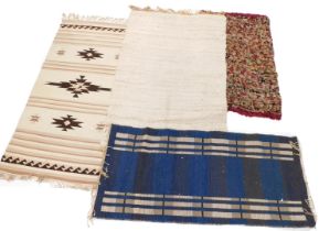 A collection of rugs, comprising a multicoloured weave, 136cm x 81cm, a cream Aztec type runner with