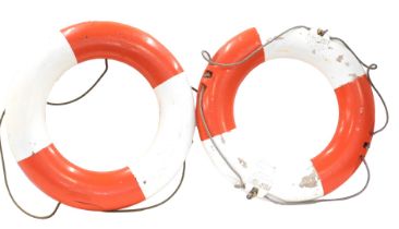 A pair of red and white striped life buoys, stamped Perrybuoy, etc., 74cm diameter.