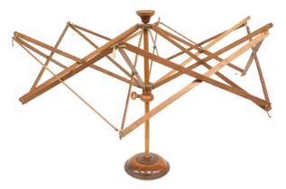 A walnut tabletop wool winder, 49cm high.