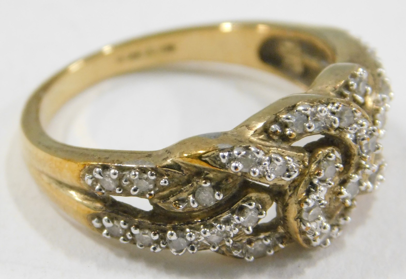 A 9ct gold and CZ set dress ring, of layered cross over design, set with tiny CZs on a yellow metal - Image 2 of 3