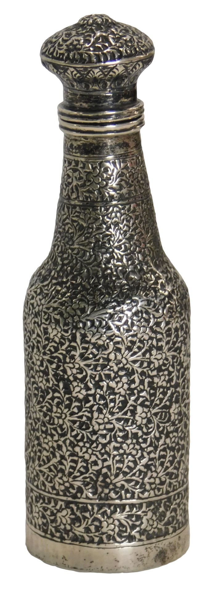 An Eastern white metal scent bottle, of hammered floral design, unmarked, 12cm high, 2.95oz.