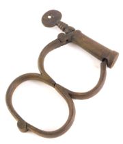 A pair of 19thC iron 'lead' police handcuffs.