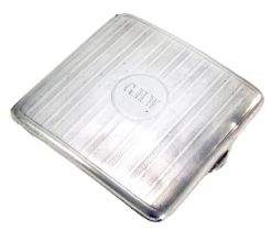 A George VI silver cigarette case, of arched form with engine turned stripe design bearing the initi