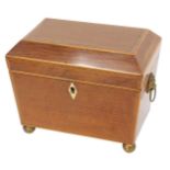 An early 19thC partridge wood tea caddy, the hinged lid enclosing two lidded divisions, on ball feet