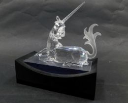 A Swarovski crystal Fabulous Creatures seated unicorn 1996, 11cm high, boxed, with display stand.