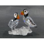 A Swarovski puffin figure group, of two puffins on perch, in blackened and orange crystal, 6cm high,