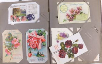 An album of early 20thC postcards and greetings cards, to include portrait photographs, classroom in